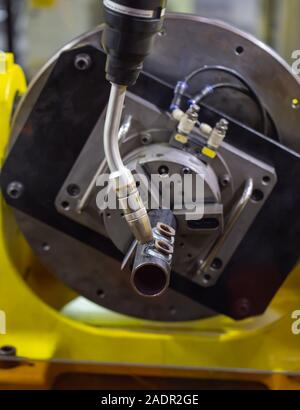 6 axis industry robotic arc machine welding nipple to pipe Stock Photo