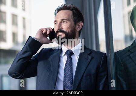 Close up of a positive businessman talking on phone Stock Photo