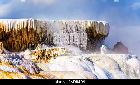 Hot Water cascading over the Edge of Canary Spring in the Mammoth Hot Springs area of Yellowstone National Park, Wyoming, United States Stock Photo