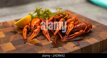 Tasty boiled crayfishes with fennel on table Stock Photo