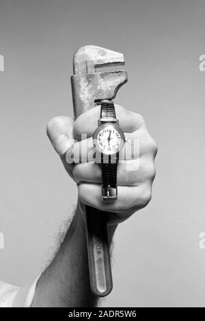 Plumber with watch and wrench Stock Photo