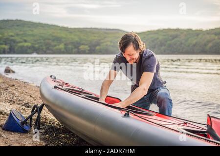 Caucasian Men Preparing For a Kayak Trip on the sea. Summer Recreation Stock Photo