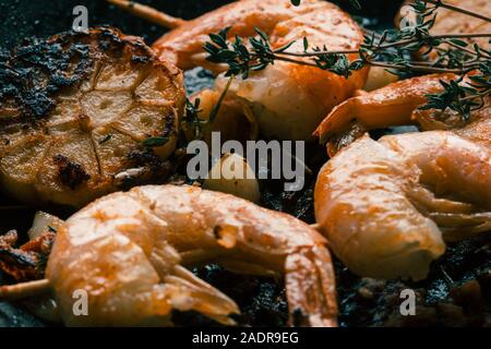 Roasted garlic and tiger prawns with herbs Stock Photo