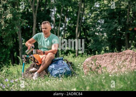 Nice young man with prosthesis resting in harmony with nature Stock Photo