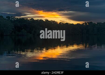 Sunset in the Amazon Rainforest River comprising the countries of Brazil, Bolivia, Colombia, Ecuador, Peru, Guyana, Suriname and Bolivia. Stock Photo