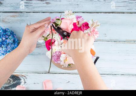 Florist preparing a bouquet of pink and red roses Stock Photo