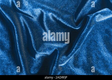 Fancy blue shiny velvet folds texture background for design, trendy 2020 year color Stock Photo