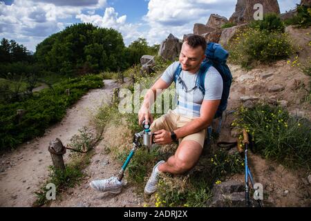 Delighted young man having a rest on his touristic route Stock Photo