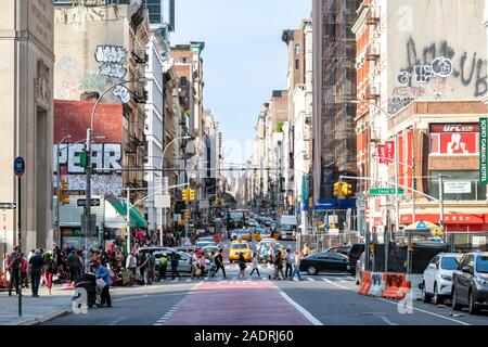 NEW YORK CITY: The sidewalks of Canal Street and Broadway are crowded with people shopping along the sidewalks and traffic in the intersection on a bu Stock Photo