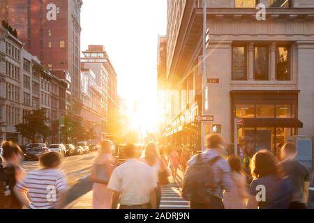 People walking down a busy sidewalk in New York City with sunlight ...
