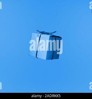 Seemless pattern of craft cardboard gift boxes on the solid blue background. Holiday and gift concept. Pop art slyle. Square Stock Photo