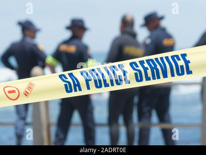 South African police yellow tape crime investigation barricade at a crime scene or search and rescue operation at the coast  in South Africa Stock Photo