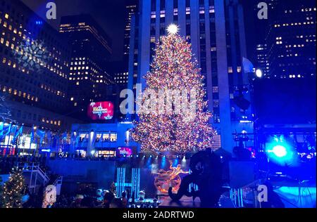 New York, USA. 04th Dec, 2019. The Christmas tree at Rockefeller Center shines brightly and brightly in the glow of lights, after the ceremony to turn on the lights for the tree. Credit: Benno Schwinghammer/dpa/Alamy Live News Stock Photo