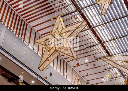 Star Decorations Hanging From The Ceiling Of A Market Stall