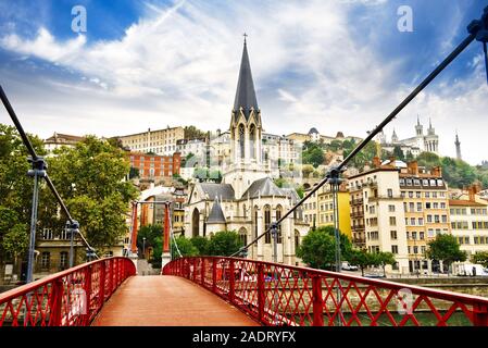 Pedestrian Saint Georges footbridge and the Saint Georges church in Lyon, France Stock Photo