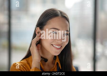 Young pretty asian woman with dark-hair smiling nicely Stock Photo