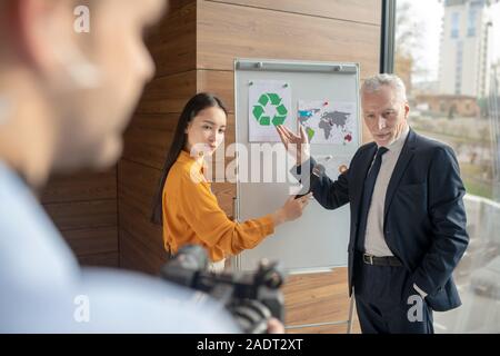 Grey-haired manager in elegant suit looking serious Stock Photo