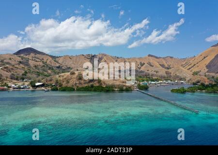 Beautiful view the Manjaja fisherman village and Saloka Island with blue and grean ocean, and traditional wooden jetty located in Labuan Bajo, Indones Stock Photo