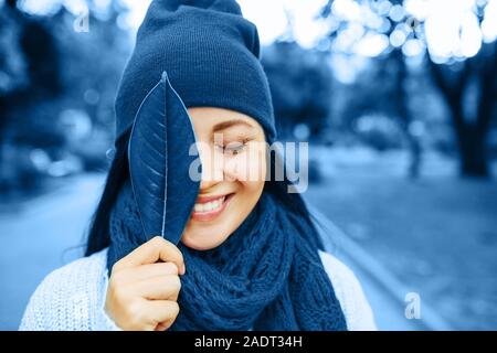 Blue fashion colors autumn-winter knits pile. Beautiful girl outside in hat and scarf. Warm cozy home and fashion colors concept. Horizontal Stock Photo