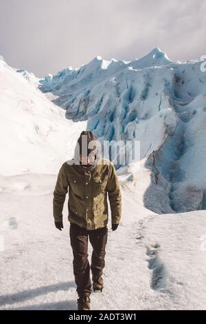 Male explorer walking on glacier Stock Photo