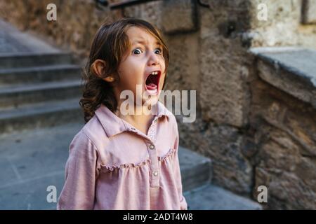 Lovely three year old girl very angry, screaming a sunny day a lot