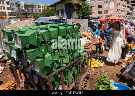 Ethiopia, Amhara Region, Bahir Dar, city centre, market, man carrying home-made metal cooking stoves on barrow through market Stock Photo