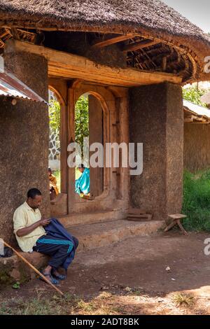 Ethiopia, Amhara Region, Bahir Dar, Lake Tana, Zege Peninsula, man in shade at gate of Ura Kidane Mehret Church Stock Photo