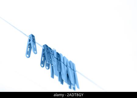 Colored clothespins on a rope on a blurred background Stock Photo