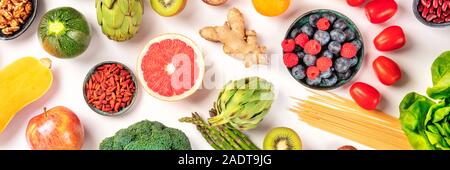 Vegan food panoramic flatlay shot. Healthy diet concept. Fruits, vegetables, pasta, nuts, legumes on a white background Stock Photo