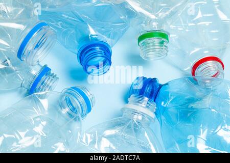 Crumpled plastic bottles on a blue background. Plastic trash. Stock Photo