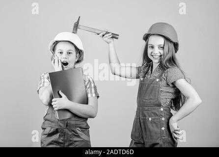 Children sisters renovation their room. Control renovation process. Kids happy renovating home. Home improvement activity. Kids girls with tools planning renovation. Family remodeling house. Stock Photo