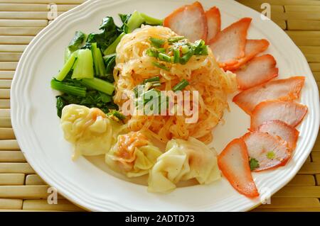 dried thin rice noodle topping barbecue pork and dumpling on plate Stock Photo