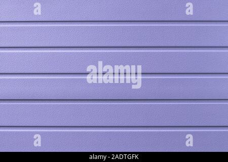 Abstract purple background with lines. Striped surface of metal fence. Metallic cladding of wall, texture. Stock Photo