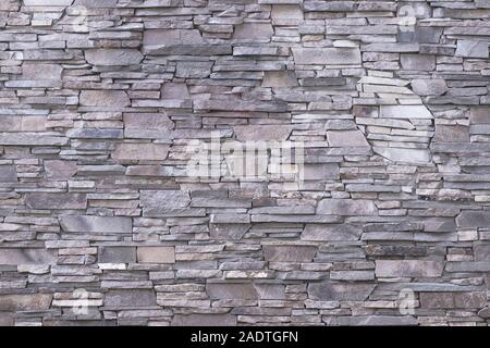 Gray stone wall background. Light texture of masonry, rough surface, modern design. Natural pattern. Abstract architecture backgrounds. Brown textured Stock Photo