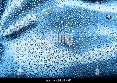 Drops of water on blue background. Macro shot. Stock Photo