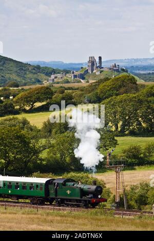 Swanage railway steam train with Corfe Castle in the background Stock Photo