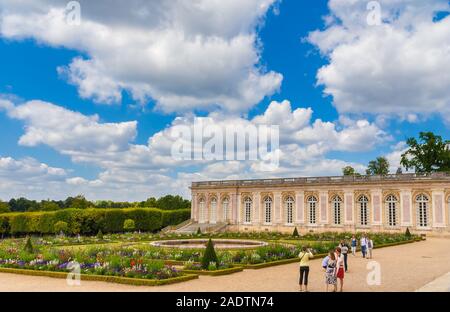 Lovely view of the orderly French garden with the Cotelle Gallery in the north wing of the Grand Trianon Palace in the background. The outdoor setting... Stock Photo