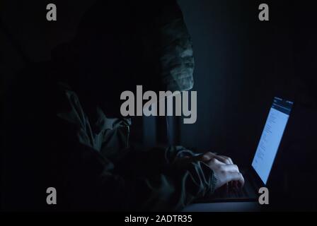hacker is in a set of black watercolors on the front. Safety concepts of cyber security information Stock Photo