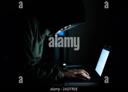 hacker is in a set of black watercolors on the front. Safety concepts of cyber security information Stock Photo