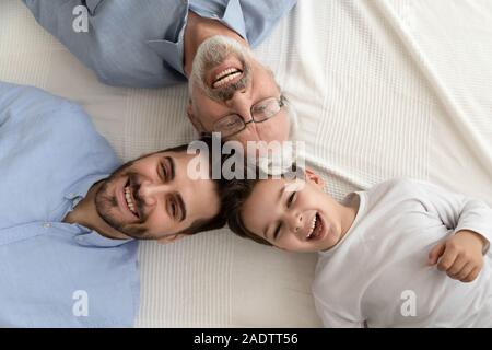 Above view happy faces grandfather grown up son and grandkid Stock Photo