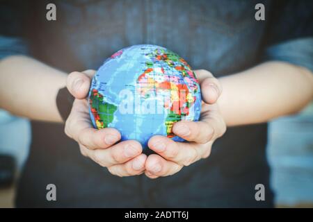 Protect our world in human hands. Human hands holding Green planet , Save earth concept. Stock Photo
