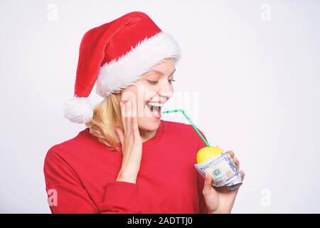 Lemon money concept. Girl santa hat drink juice lemon wrapped in banknote. Totally natural lemon juice. Fresh lemonade drink with straw. Symbol of wealth and richness. Girl with lemon and money. Stock Photo