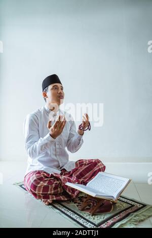 muslim asian man praying to god Stock Photo