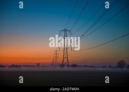 Electricity Pylons at sunset on the Somerset Levels Neil Phillips Photo and Film Dec 4 2019 Stock Photo
