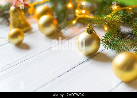 Beautiful christmas decoration (baubles, lights, pine branches) on old white, wooden background. Place for text included Stock Photo