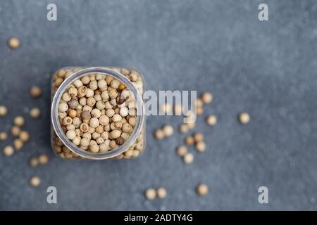 White peppers on grey stone background. Copy space. Top view Stock Photo