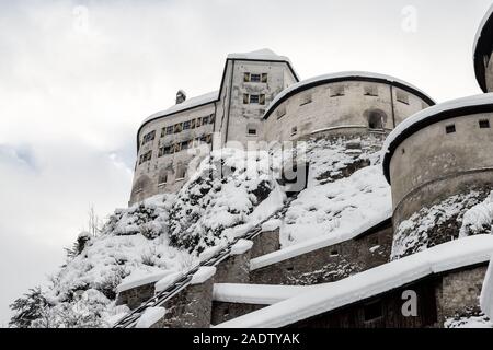 Old medieval european unassailable fortress or castle on hill at alpine austrian Kufstein city covered with big snow layer after blizzard in winter Stock Photo