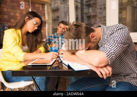 Young tired team working on hard bussiness project Stock Photo