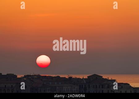 sunset with big red sun just above horizon at Tropea horizontal Stock Photo