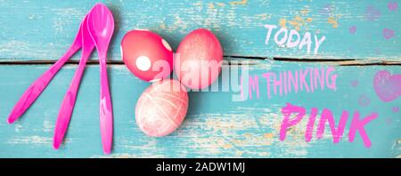 Header, red dyed eggs and spoons on blue wooden table, text tody i am thinking pink Stock Photo